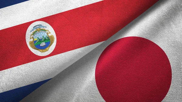 Costa Rica y Japón dos banderas tela textil, textura de la tela — Foto de Stock