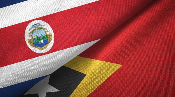 Costa Rica en Timor-leste Oost-Timor twee vlaggen textiel doek, stof textuur — Stockfoto