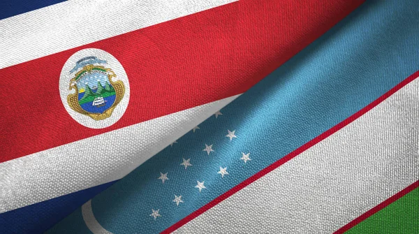 Costa Rica och Uzbekistan två flaggor textil tyg, tyg konsistens — Stockfoto