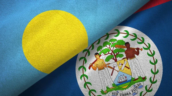 Palau i Belize dwie flagi tkanina tekstylna, tekstura tkaniny — Zdjęcie stockowe