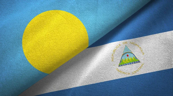 Palau and Nicaragua two flags textile cloth, fabric texture — Stock Photo, Image