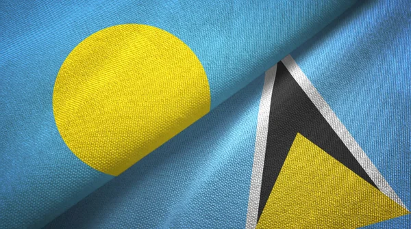 Palau és Saint Lucia két zászló textil ruhával, szövet textúra — Stock Fotó