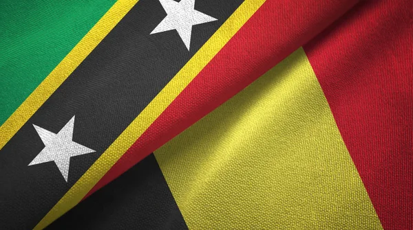 Saint Kitts e Nevis e Belgio due bandiere tessuto, tessitura del tessuto — Foto Stock