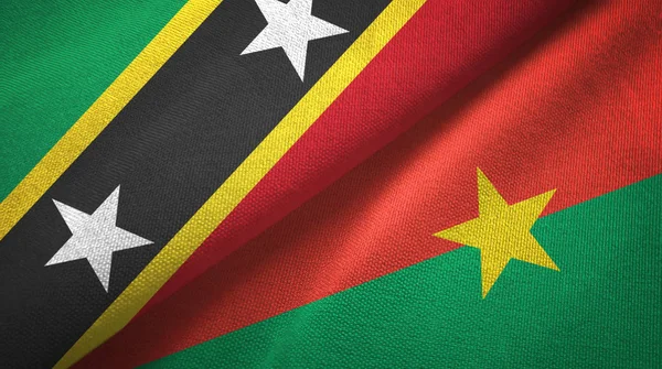 Saint Kitts e Nevis e Burkina Faso due bandiere tessuto, tessitura del tessuto — Foto Stock