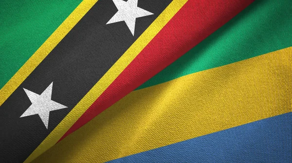 Saint Kitts and Nevis and Gabon two flags textile cloth, fabric texture — Stock Photo, Image