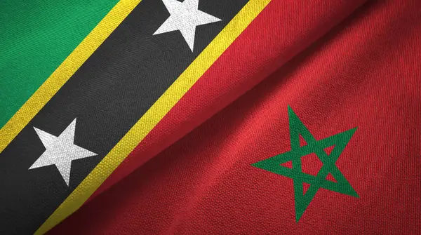 Saint Kitts en Nevis en Marokko twee vlaggen textiel doek, stof textuur — Stockfoto