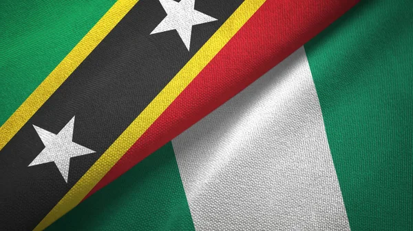 São Cristóvão e Nevis e Nigéria duas bandeiras de pano têxtil, textura de tecido — Fotografia de Stock