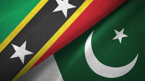 São Cristóvão e Nevis e Paquistão duas bandeiras pano têxtil, textura de tecido — Fotografia de Stock