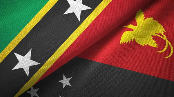 Saint Kitts e Nevis e Papua Nuova Guinea due bandiere tessuto — Foto Stock