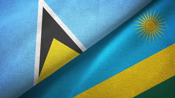 Saint Lucia i Rwanda dwie flagi tkanina tekstylna, tekstura tkaniny — Zdjęcie stockowe