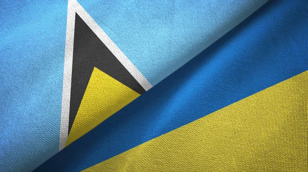 Santa Lucía y Ucrania dos banderas tela textil, textura de la tela —  Fotos de Stock