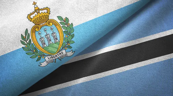 San Marino y Botswana dos banderas tela textil, textura de la tela — Foto de Stock