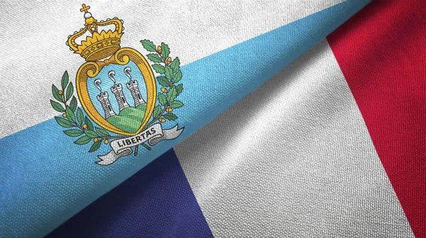 San Marino och Frankrike två flaggor textil trasa, tyg konsistens — Stockfoto