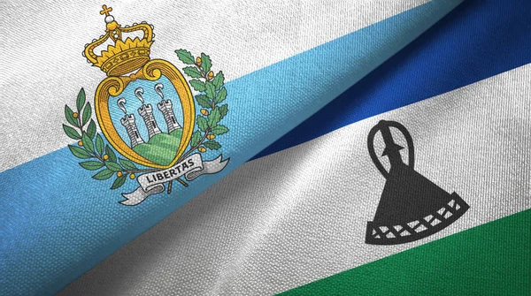 San Marino y Lesotho dos banderas tela textil, textura de la tela — Foto de Stock