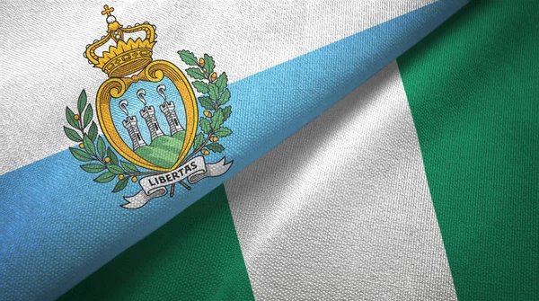 San Marino e Nigéria duas bandeiras de pano têxtil, textura de tecido — Fotografia de Stock