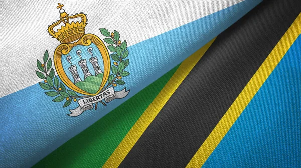 San Marino y Tanzania dos banderas tela textil, textura de la tela — Foto de Stock