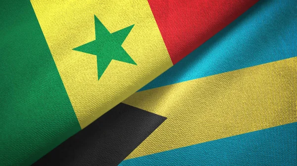 Senegal och Bahamas två flaggor textil trasa, tyg textur — Stockfoto