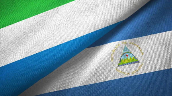 Sierra Leone and Nicaragua two flags textile cloth, fabric texture — Stock Photo, Image