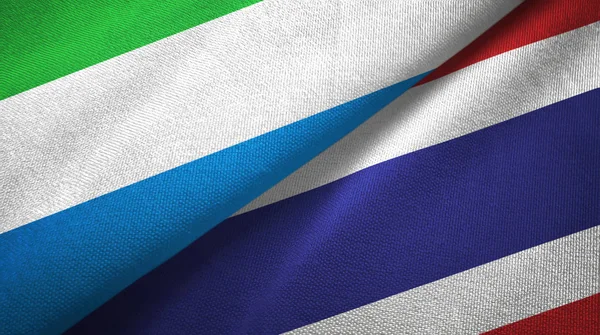 Serra Leoa e Tailândia duas bandeiras de pano têxtil, textura de tecido — Fotografia de Stock