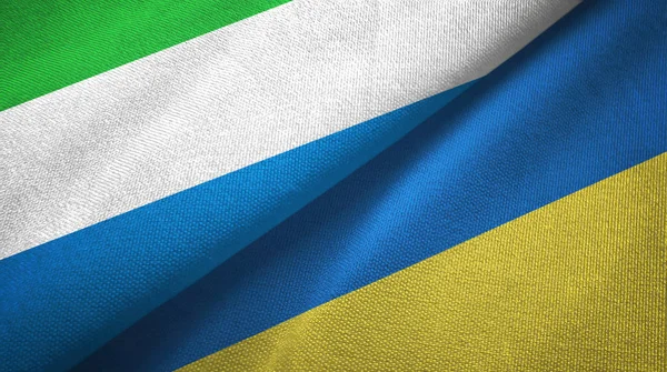 Sierra Leona y Ucrania dos banderas tela textil, textura de la tela —  Fotos de Stock
