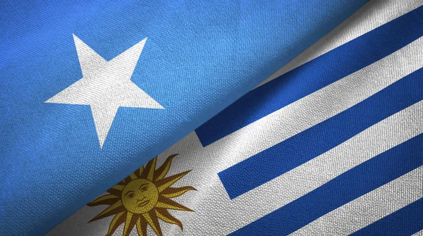 Сомали и Уругвая два флага текстильная ткань, текстура ткани — стоковое фото