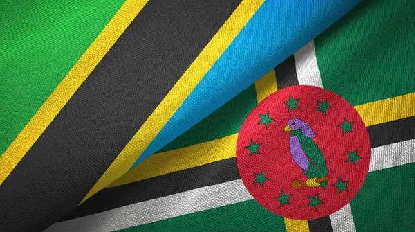 Tanzania och Dominica två flaggor textil trasa, tyg konsistens — Stockfoto