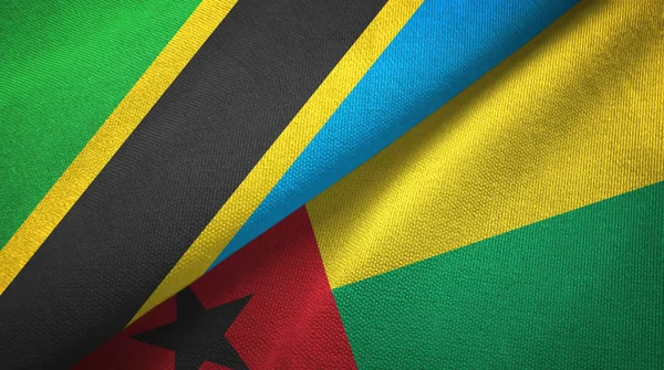 Tanzania en Guinee-Bissau twee vlaggen textiel doek, weefsel textuur — Stockfoto