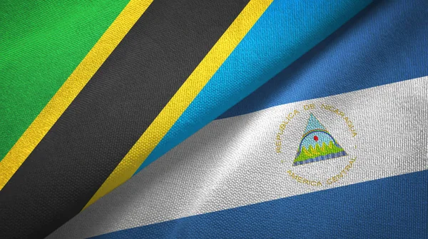 Tansania und Nicaragua zwei Flaggen Textilstoff, Textur — Stockfoto