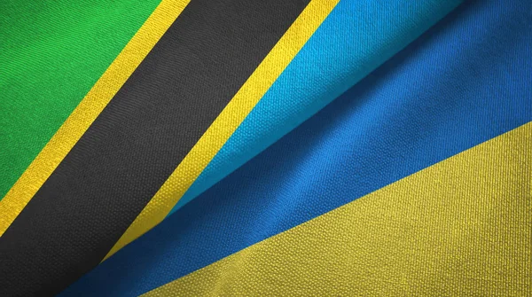 Tansania und Ukraine zwei Flaggen Textilstoff, Textiltextur — Stockfoto