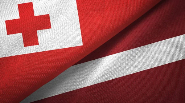 Tonga och Lettland två flaggor textil tyg, tyg konsistens — Stockfoto