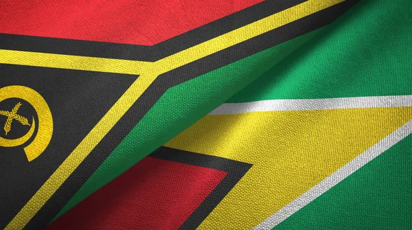 Vanuatu e Guyana due bandiere tessuto, tessitura del tessuto — Foto Stock