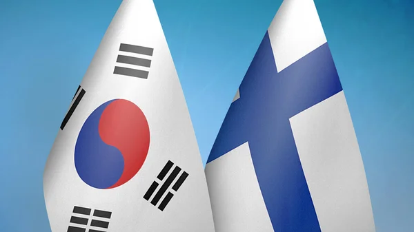 韓国とフィンランドの2つの旗が青い背景を持っています — ストック写真