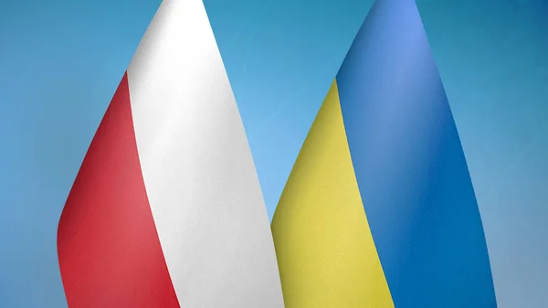 Poland and Ukraine two flags together blue background