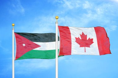 Ürdün ve Kanada bayrak direkleri üzerinde iki bayrak ve mavi bulutlu arka plan