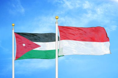 Ürdün ve Endonezya bayrak direkleri üzerinde iki bayrak ve mavi bulutlu arka plan