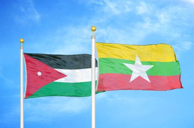 Jordan ve Myanmar bayrak direğinde iki bayrak ve mavi bulutlu arka plan