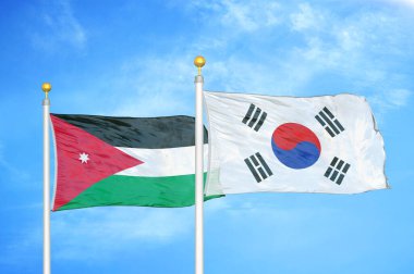 Ürdün ve Güney Kore bayrak direğinde iki bayrak ve mavi bulutlu arka plan