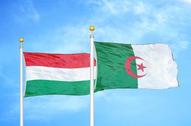Macaristan ve Cezayir bayrak direkleri üzerinde iki bayrak ve mavi bulutlu arka plan