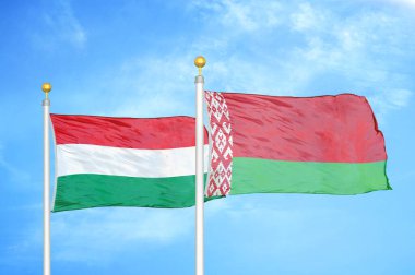 Macaristan ve Belarus bayrak direkleri ve mavi bulutlu arka planda iki bayrak