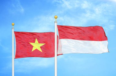 Vietnam ve Endonezya bayrak direkleri üzerinde iki bayrak ve mavi bulutlu arka plan