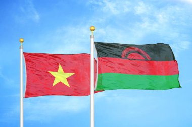 Vietnam ve Malawi bayrak direkleri üzerinde iki bayrak ve mavi bulutlu arka plan