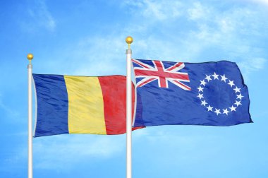 Romanya ve Cook Adaları bayrak direkleri ve mavi bulutlu arka planda iki bayrak