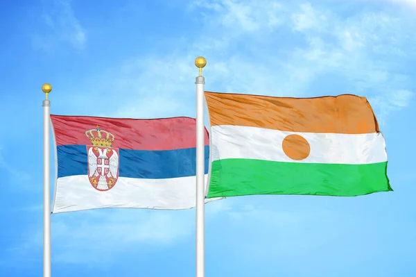 Serbia Niger Two Flags Flagpoles Blue Cloudy Sky Background — Stock Photo, Image