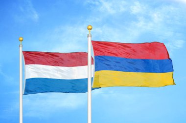 Hollanda ve Ermenistan bayrak direkleri ve mavi bulutlu arka planda iki bayrak