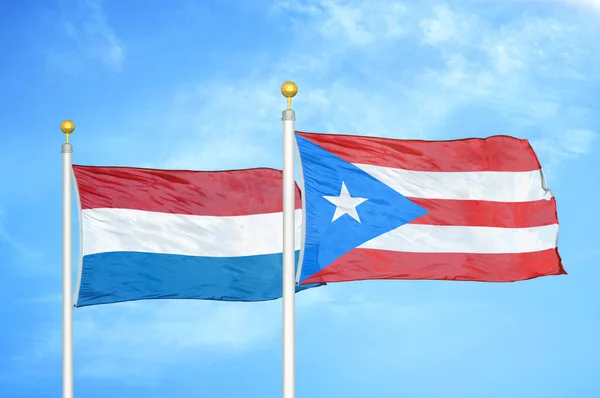 Nizozemsko Portoriko Dvě Vlajky Vlajkových Stožárech Modrá Oblačná Obloha Pozadí — Stock fotografie