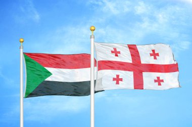 Sudan ve Gürcistan bayrak direkleri üzerinde iki bayrak ve mavi bulutlu arka plan