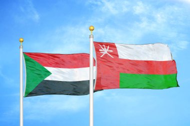 Sudan ve Umman bayrak direğinde iki bayrak ve mavi bulutlu arka plan