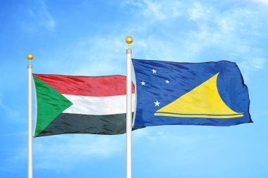 Sudan ve Tokelau bayrak direkleri ve mavi bulutlu arka planda iki bayrak