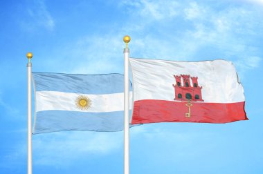 Arjantin ve Gibraltar bayrak direğinde iki bayrak ve mavi bulutlu arka plan