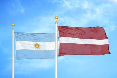 Arjantin ve Letonya bayrak direkleri ve mavi bulutlu arka planda iki bayrak